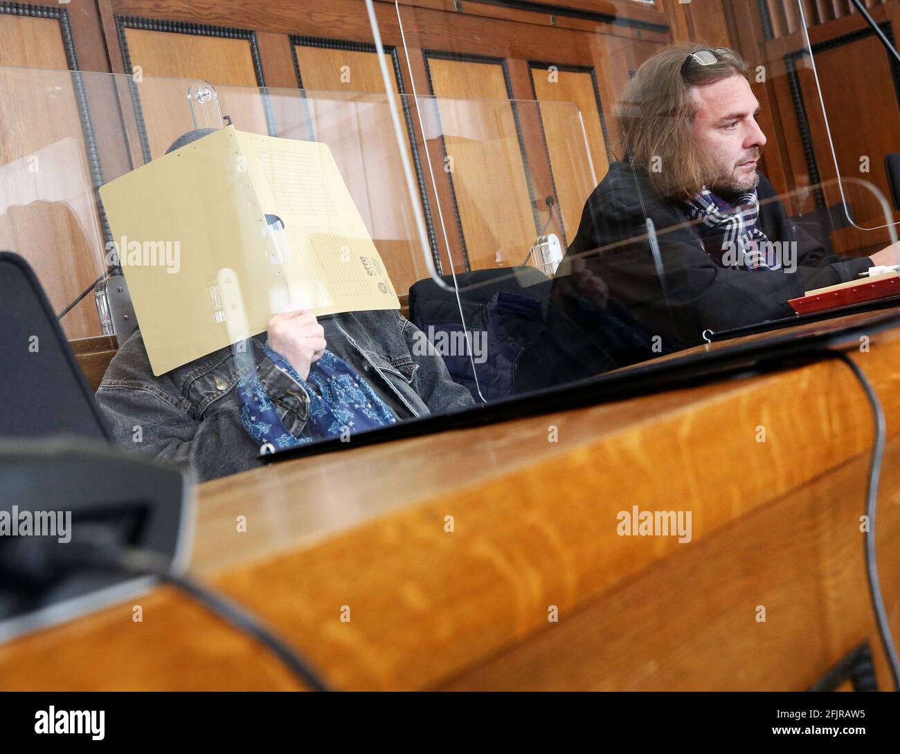 26 April 2021, North Rhine-Westphalia, Mönchengladbach: The accused nurse (l) waits in the courtroom with his lawyer Markus Kluck for his trial to begin. The 64-year-old is alleged to have killed a patient in orthopaedics with an overdose of sedatives in a hospital for people with special needs. Photo: Roland Weihrauch/dpa Stock Photo