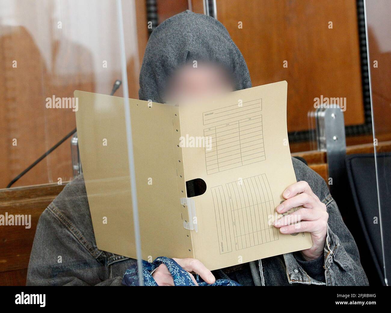26 April 2021, North Rhine-Westphalia, Mönchengladbach: The accused nurse waits in the courtroom for the trial to begin. The 64-year-old is alleged to have killed a patient in orthopaedics with an overdose of sedatives in a hospital for people with special needs. Photo: Roland Weihrauch/dpa - ATTENTION: Person(s) have been pixelated for legal reasons Stock Photo