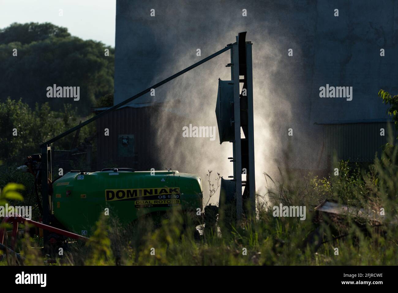 Rawa Mazowiecka, Poland - July 18, 2020: Spraying cherries. Protection of the orchard and trees against pests and diseases. Work on a fruit farm. Stock Photo