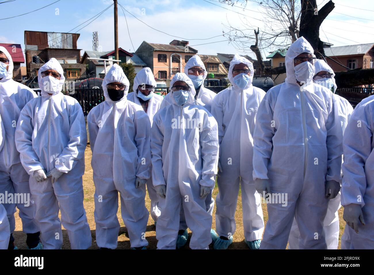 Srinagar, Jammu and kashmir India 07 August 2020. White Kit wearing frontline men warriors are in a single line and ready to fight against coronavirus Stock Photo