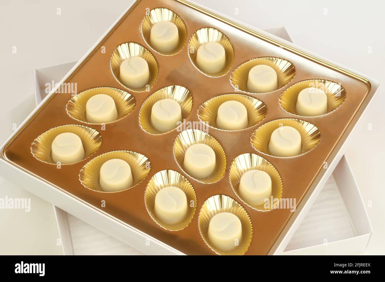 15 white chocolates in a golden box Stock Photo