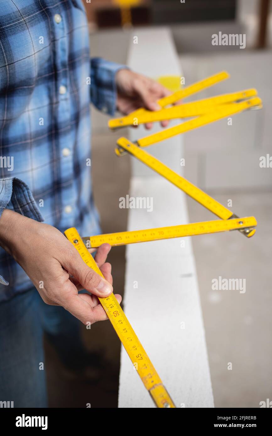 pretty young worker woman with blue work shirt working on construction ...