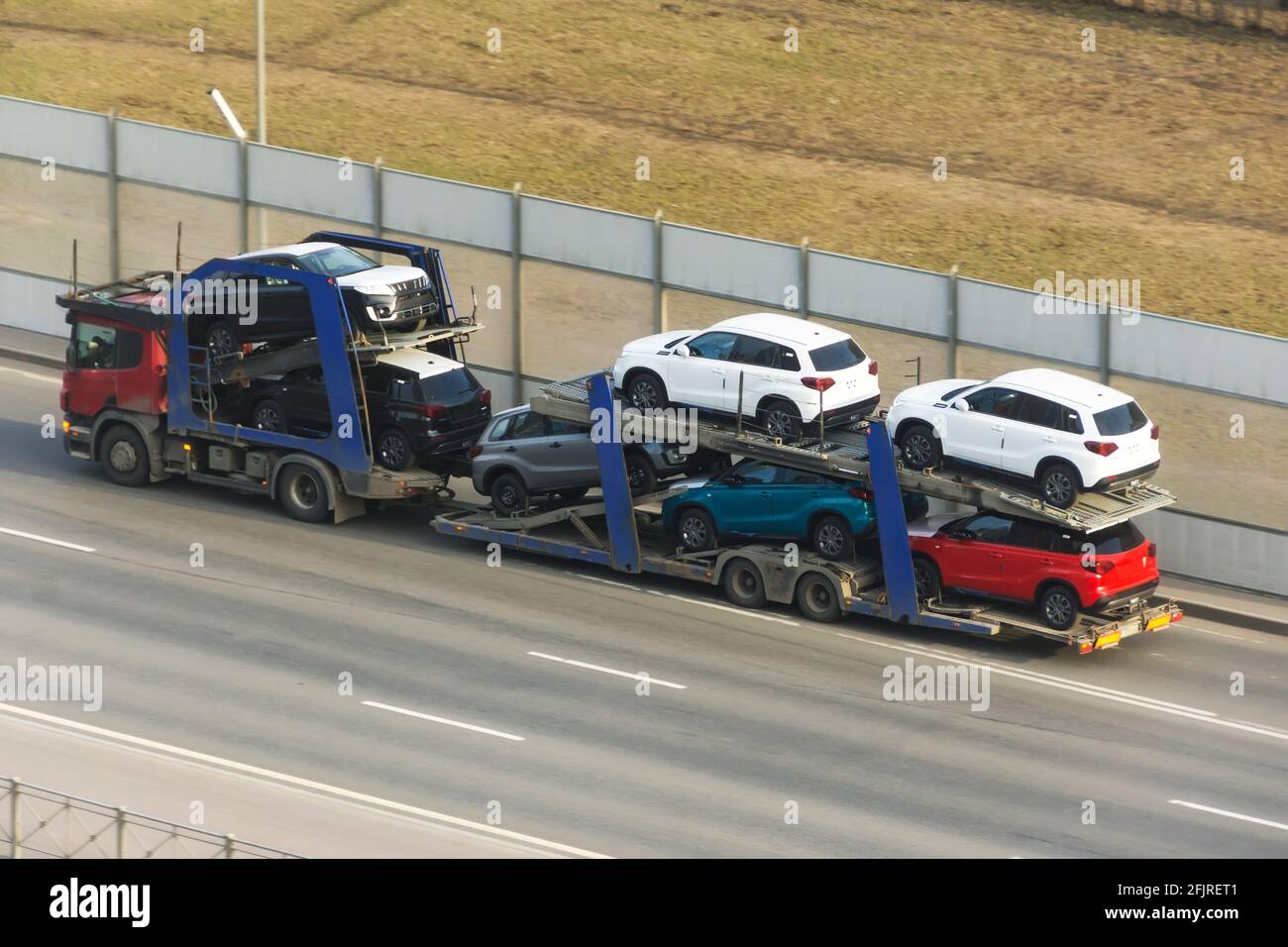 Transportation of new cars on a trailer with a truck for delivery to