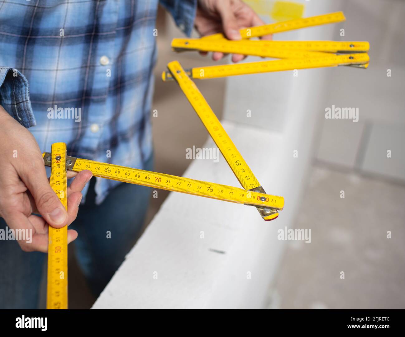 pretty young worker woman with blue work shirt working on construction ...