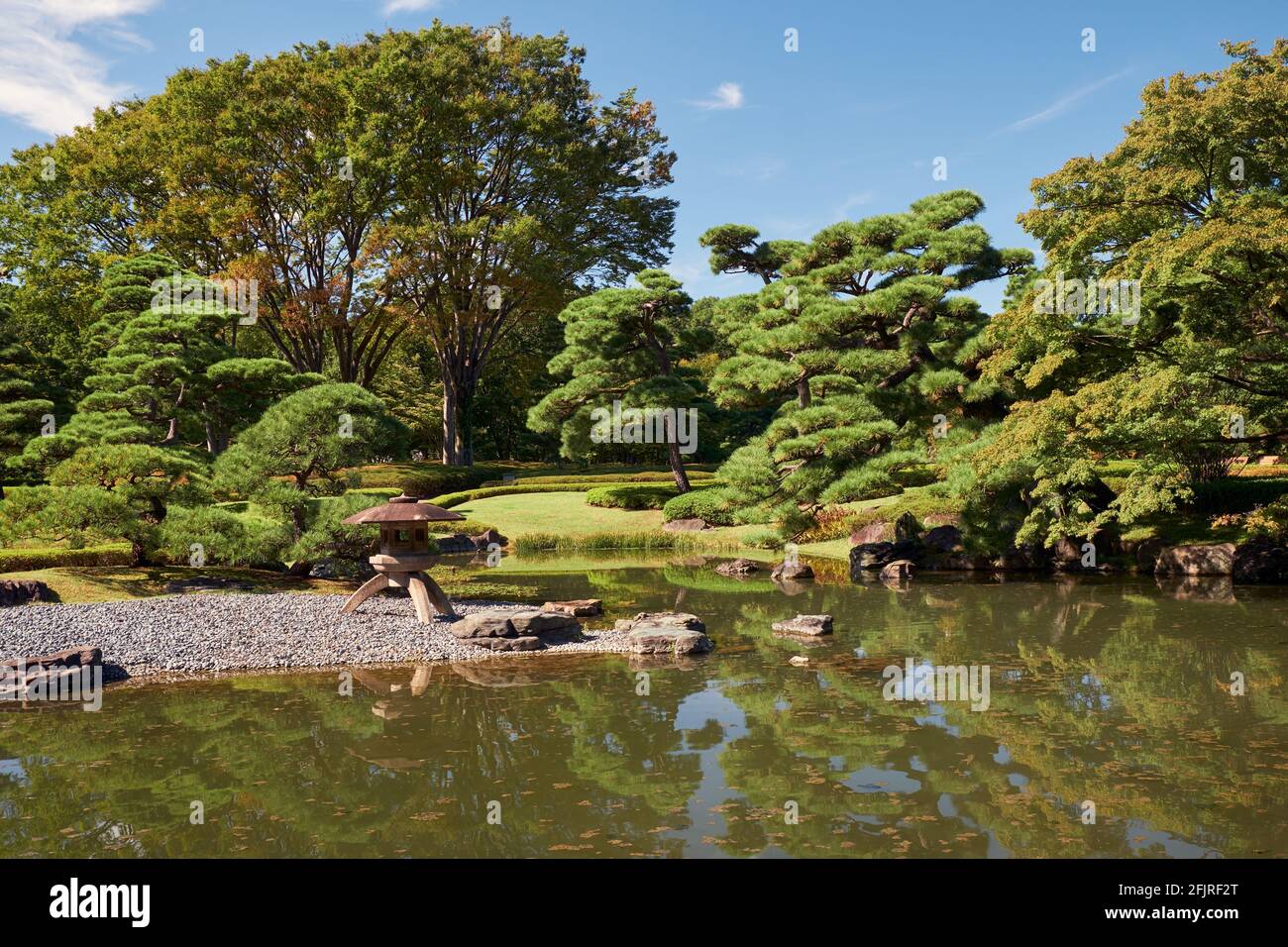 Pond in the Ninomaru Garden in nearly the same position as the original garden designed by Kobori Enshu at the foot of the Edo castle hill. Imperial P Stock Photo