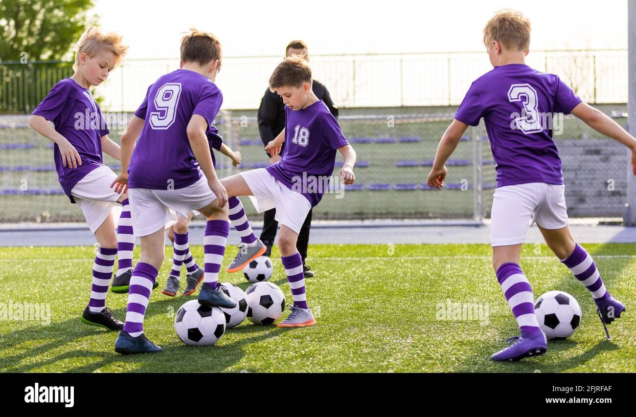 Children Sports Team Kicking Football Match on Grass Pitch. Soccer