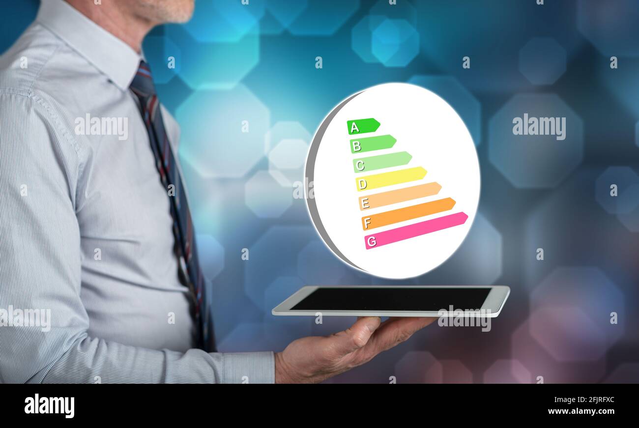 Energy efficiency concept above a tablet held by a man Stock Photo