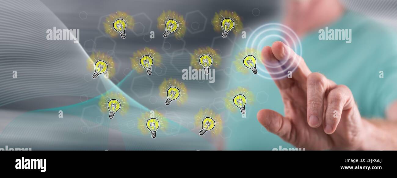 Man touching light bulbs on a touch screen with his finger Stock Photo