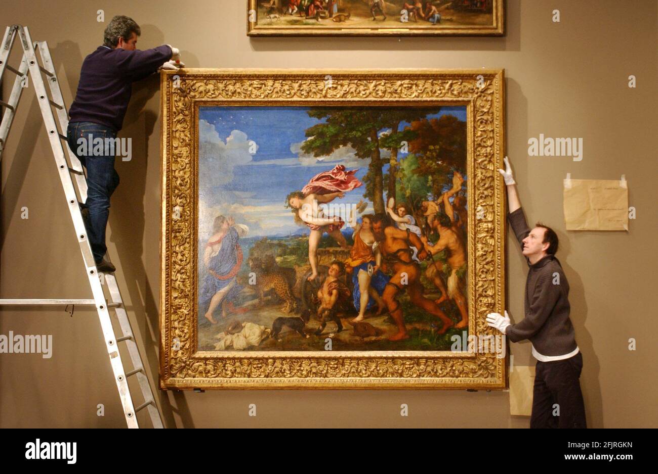 DURNG PREPERATIONS FOR THE TITIAN EXHIBITION AT THE NATIONAL GALLERY,STAFF HANG 'BACCHUS AND