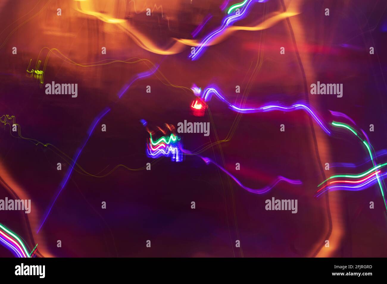Long exposure photo of colorful moving lights creating beautiful abstract patterns. Stock Photo