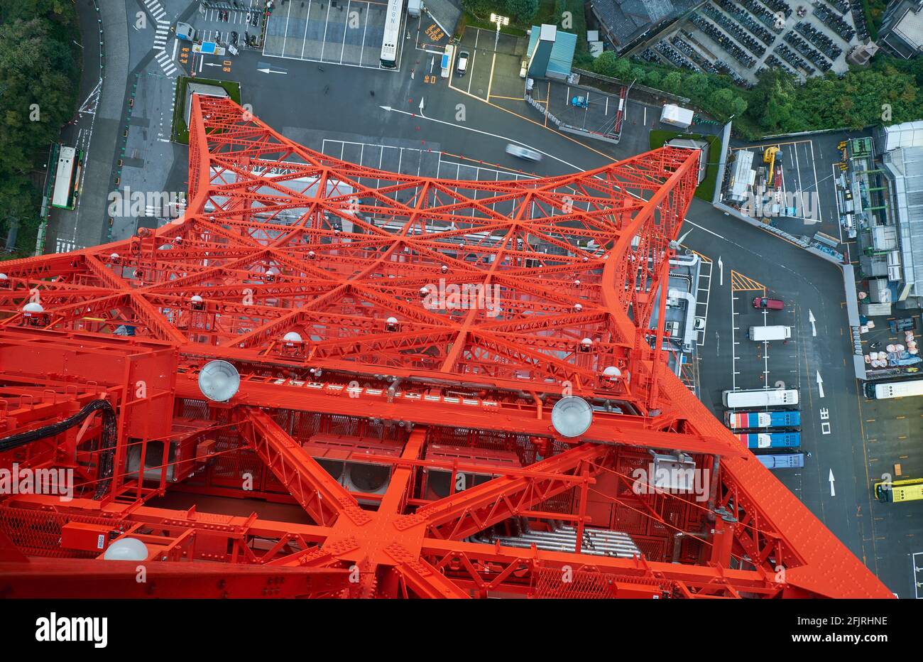The view down to the vermilion lattice metal construction of the Tokyo Tower through the glass-flooring on the main observation deck. Japan Stock Photo