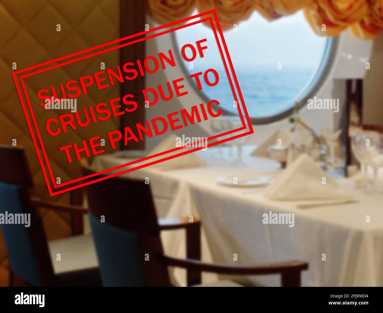 Suspension of cruise ships to due the pandemic stamp on interior restaurant cruise ship in background Stock Photo