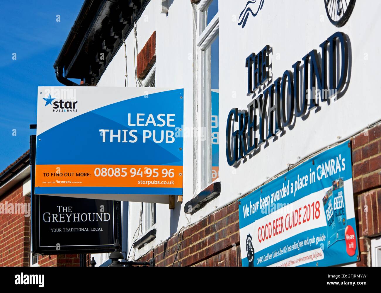 The Greyhound pub, in the village of Riccall, with a sign - Lease this pub - North Yorkshire, England UK Stock Photo