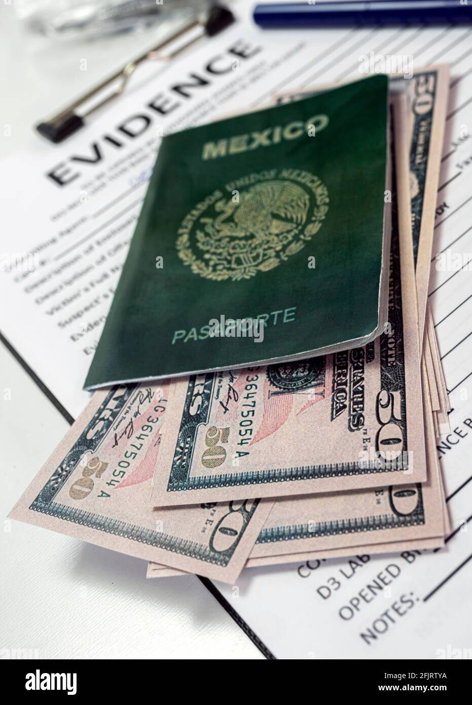 Some fifty-dollar notes in a Mexican passport in a crime lab, concept image Stock Photo