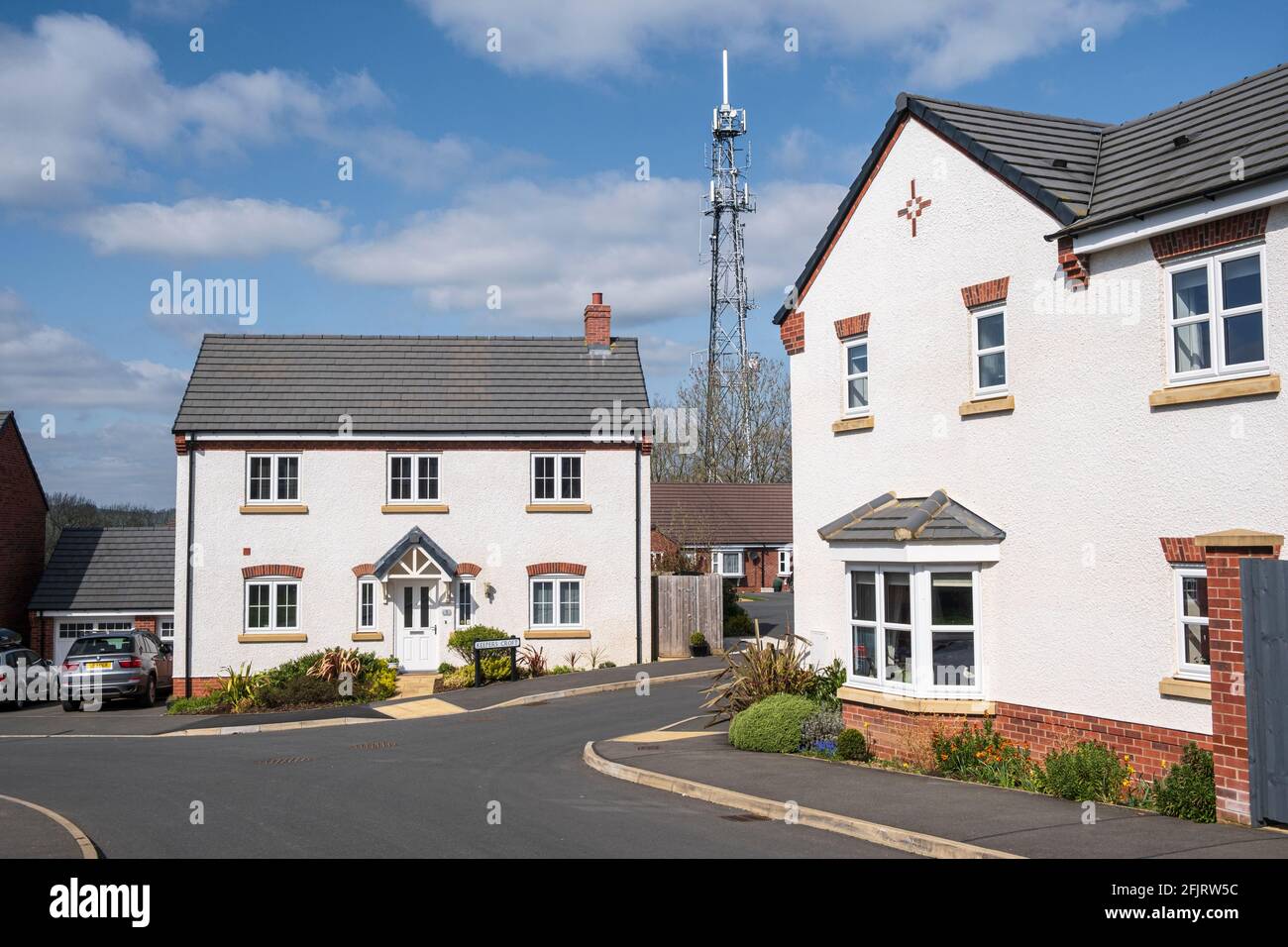 Phone mast near a new housing estate, Ashbourne, Derbyshire Stock Photo