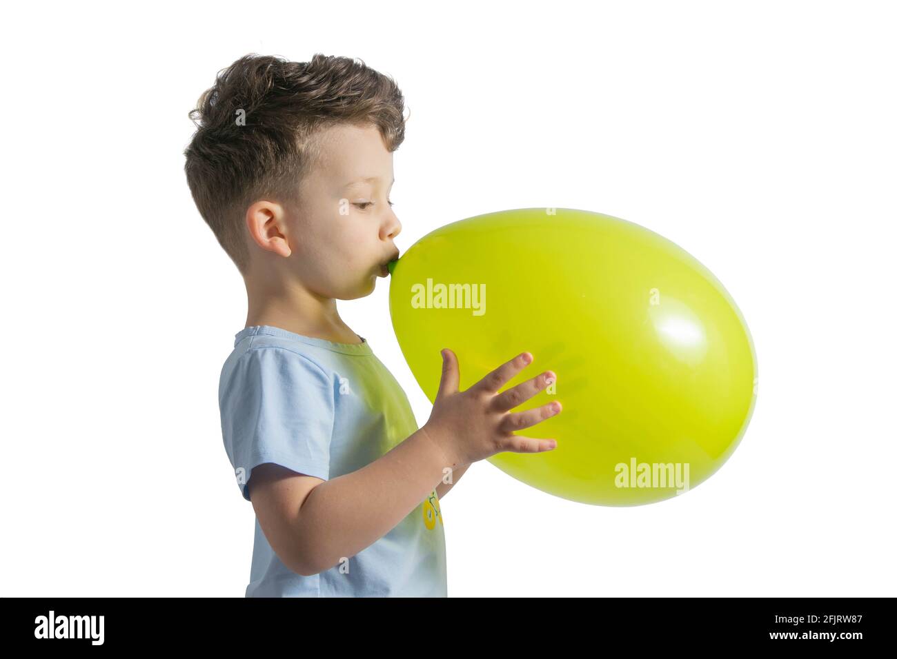 Funny boy blowing up a yellow balloon isolated on white background Stock  Photo - Alamy