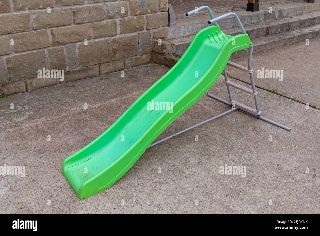 Empty Green Plastic Slide Slope Children Playground Stock Photo - Alamy