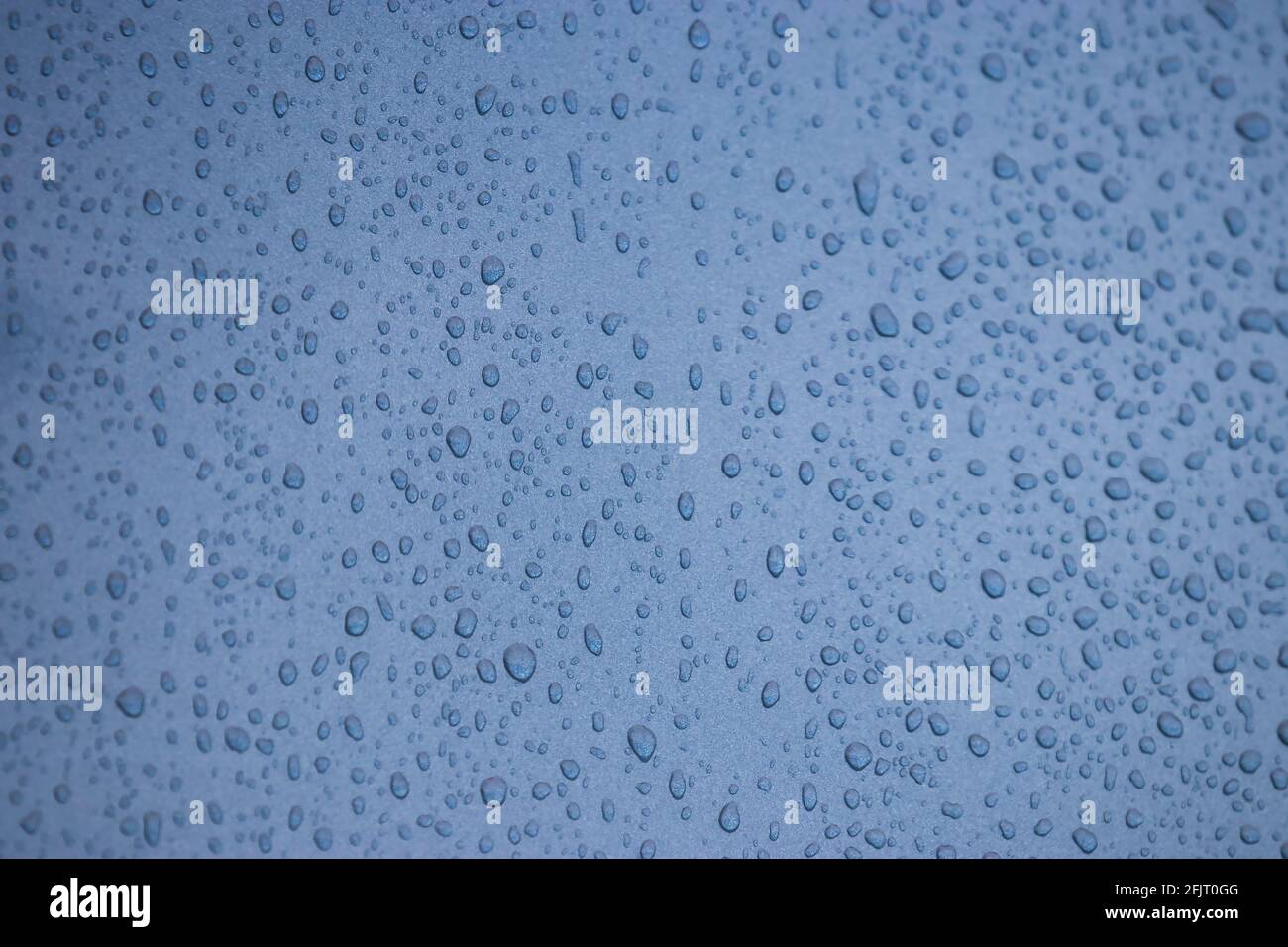 Blue abstract sky and raindrops on glass window Stock Photo