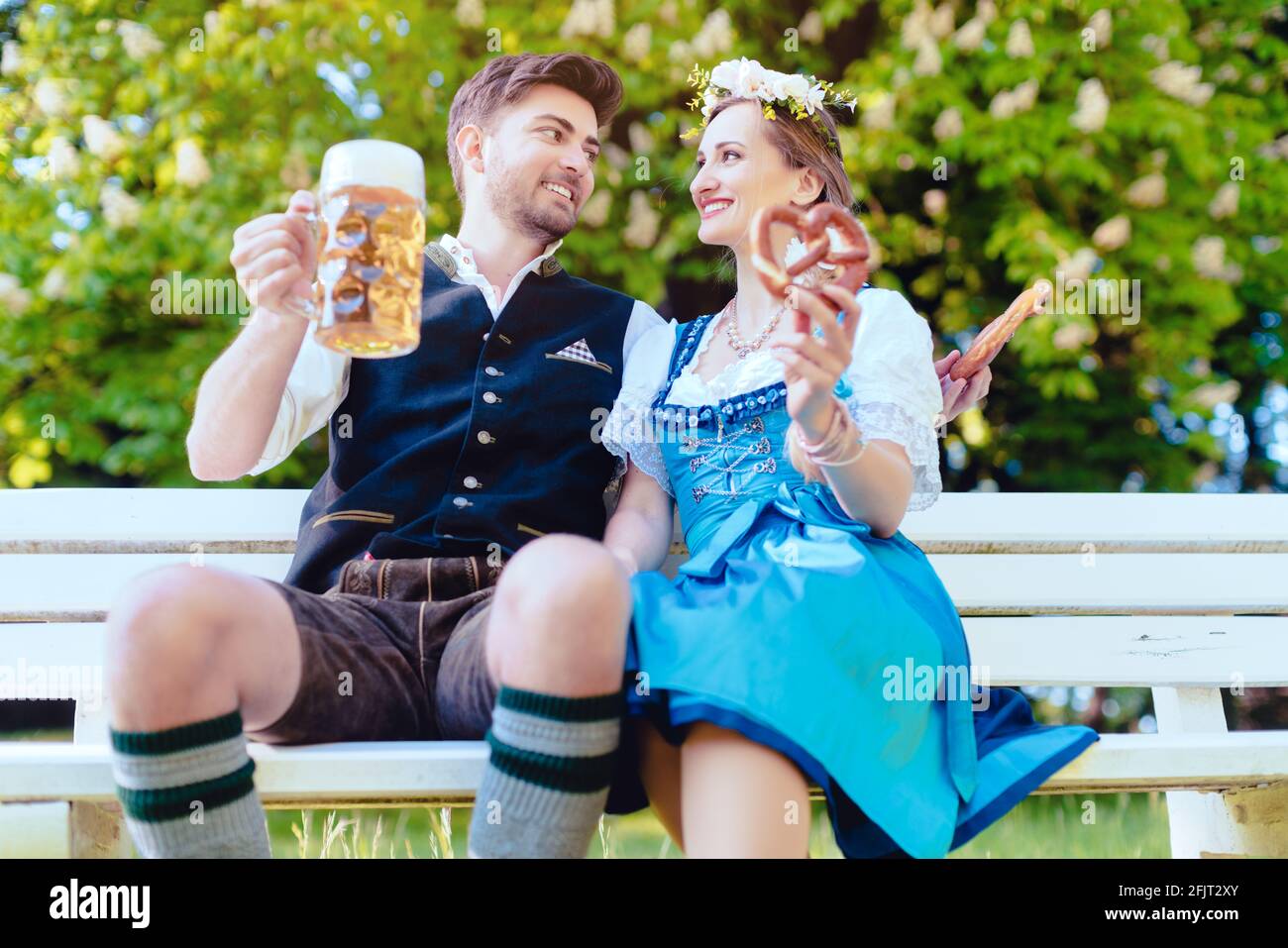 Woman and man in Bavarian tracht enjoying the country Stock Photo