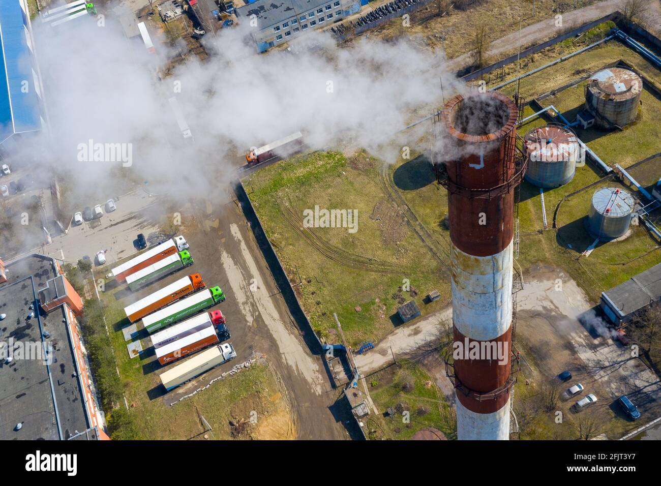 Aerial view of an industrial building with smoke rising from the ...