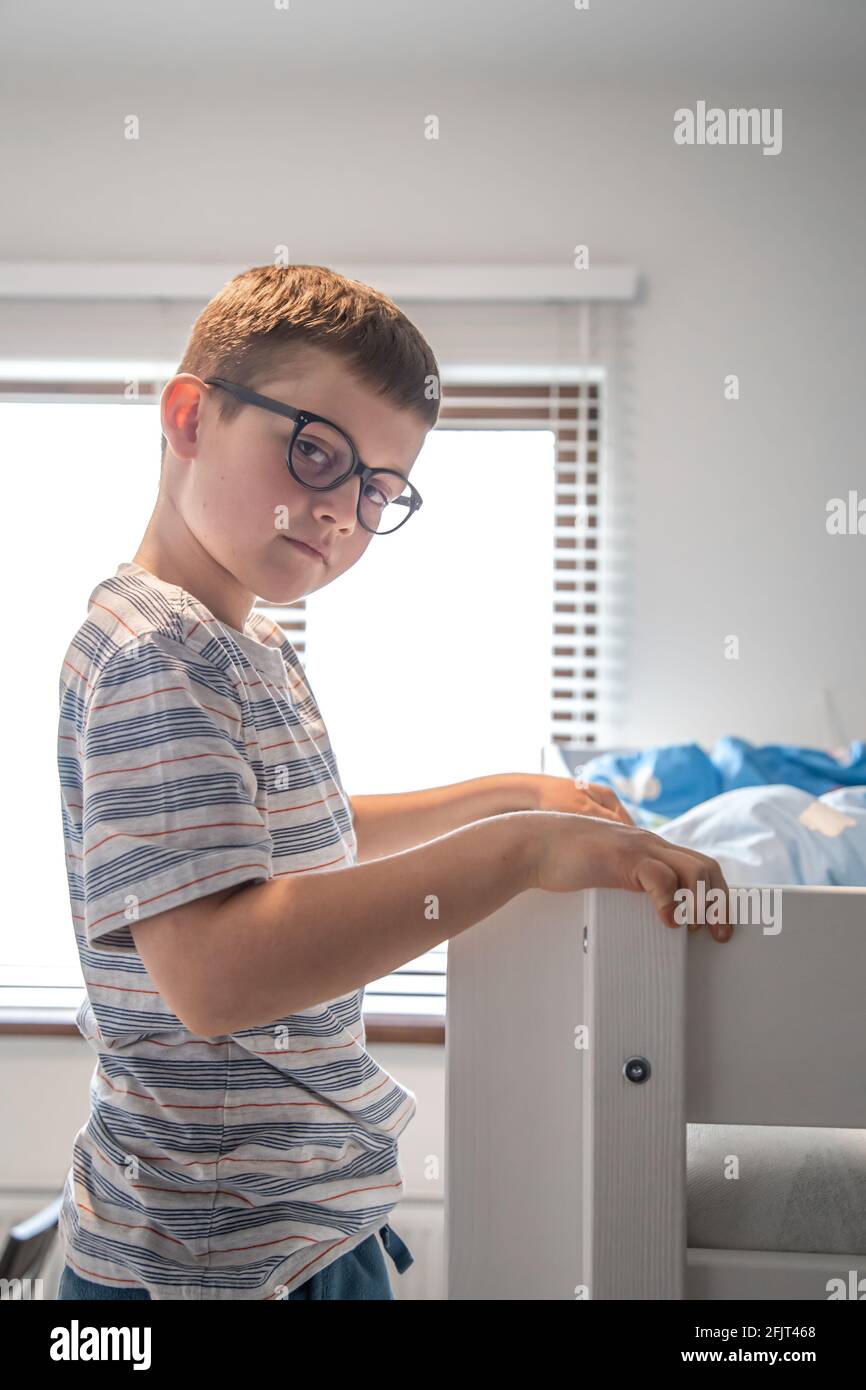 A cute little boy in his room is looking at the camera Stock Photo - Alamy
