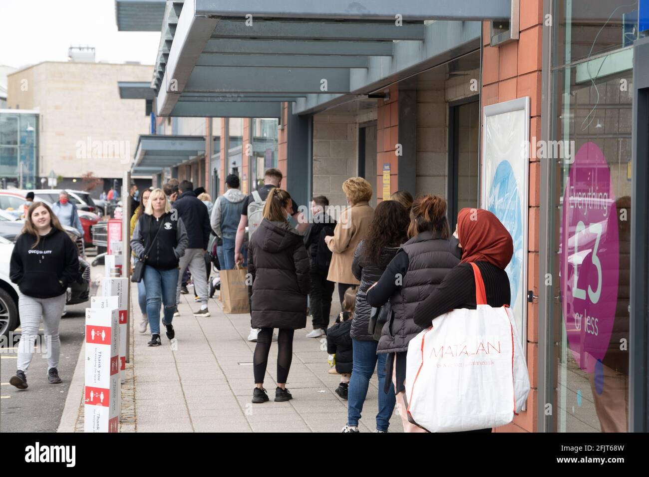 Dundee, Tayside, Scotland, 26.04.21: Large queues wait to enter TK Maxx at the Gallagher Retail Park in Dundee, as Scotland leaves its second lockdown and restrictions are relaxed, and the shops open up again. Credit: Barry Nixon Stable Air Media/17�Թ����� Live News Stock Photo