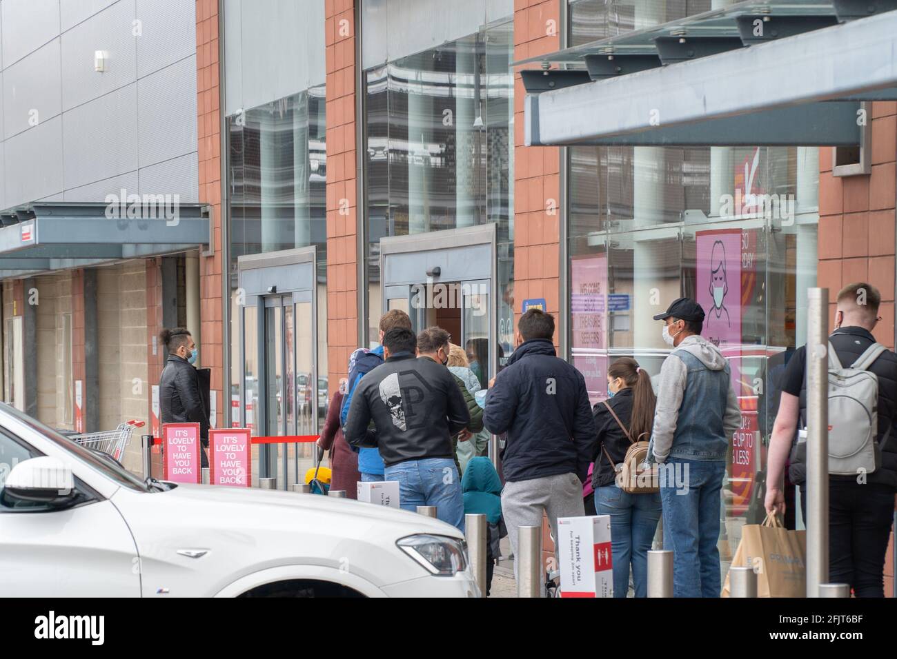 Dundee, Tayside, Scotland, 26.04.21: Large queues wait to enter TK Maxx at the Gallagher Retail Park in Dundee, as Scotland leaves its second lockdown and restrictions are relaxed, and the shops open up again. Credit: Barry Nixon Stable Air Media/Alamy Live News Stock Photo