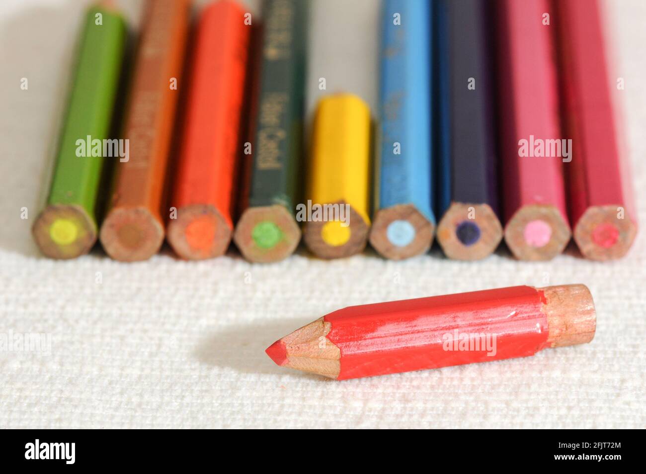 Colorful and funny arrangement of a set of pencils and ink pots Stock Photo