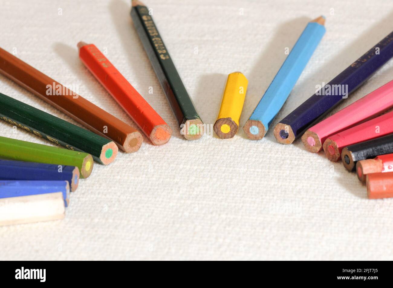 Colorful and funny arrangement of a set of pencils and ink pots. Stock Photo