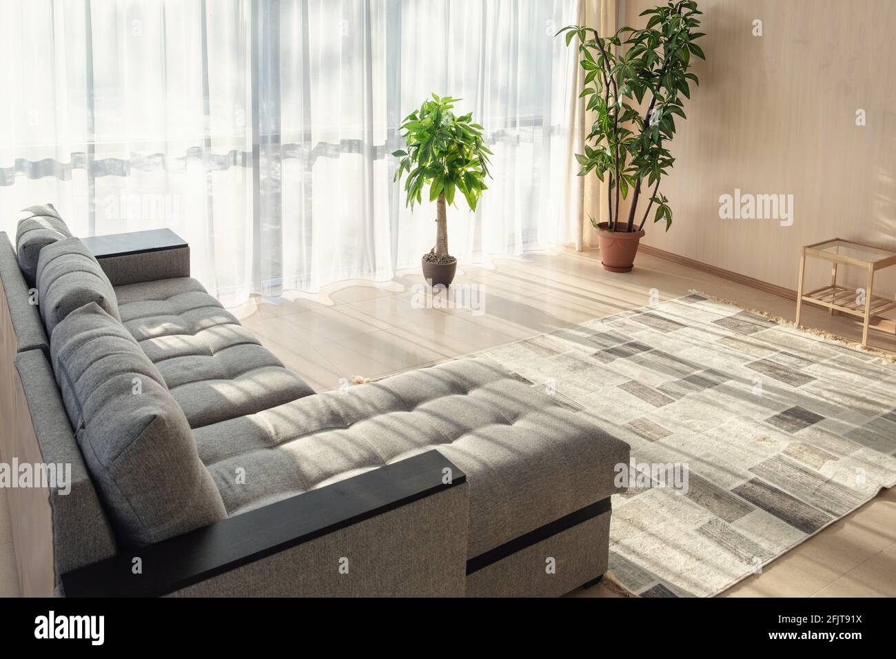 Modern interior with big sofa and a large windows - Image Stock Photo