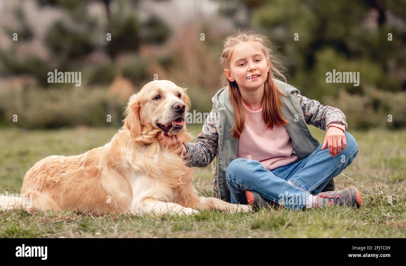 Little girl with golden retriever dog outside Stock Photo - Alamy