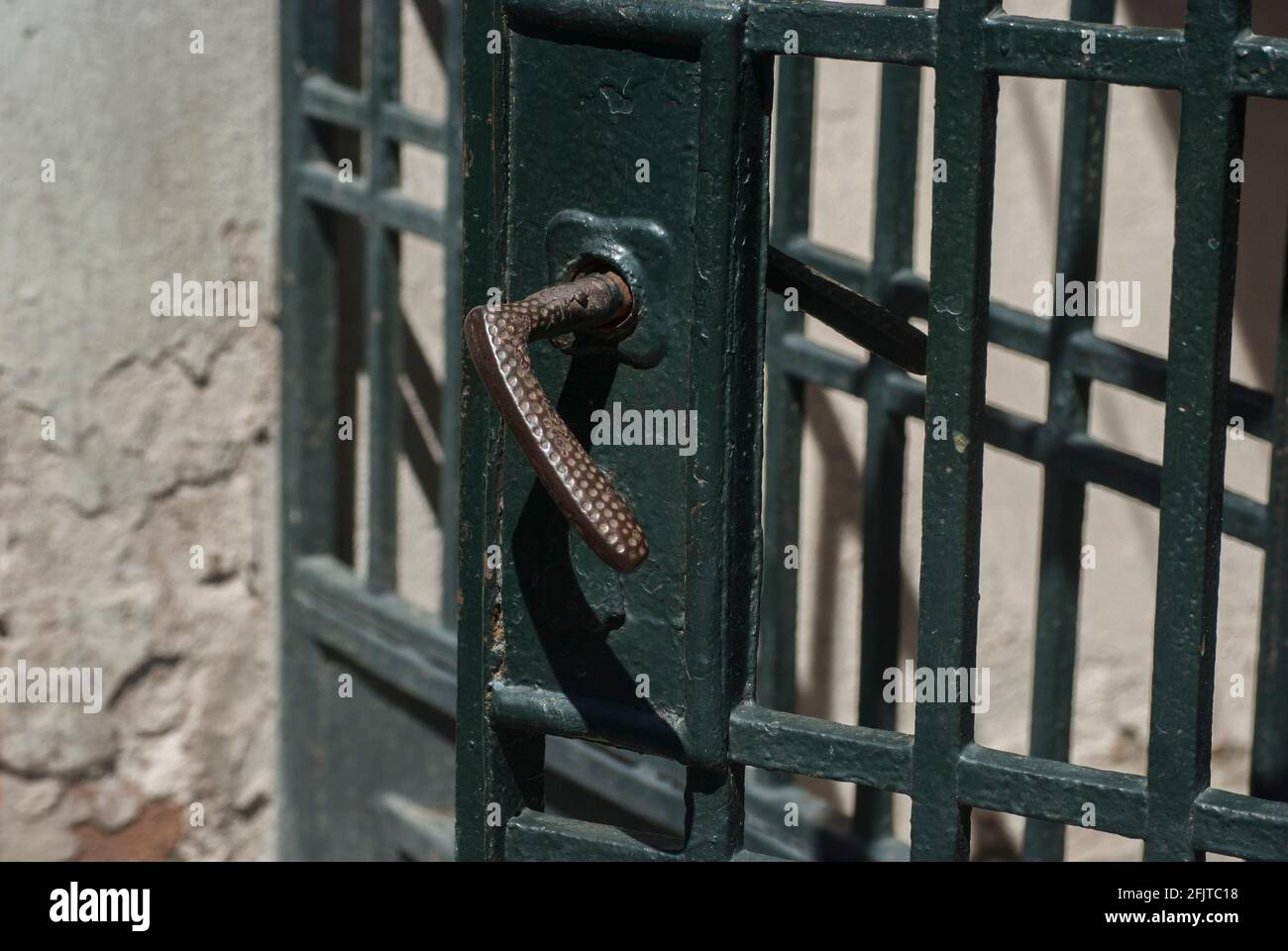Old retro vintage iron lock and handle of metal garden door closeup Stock Photo