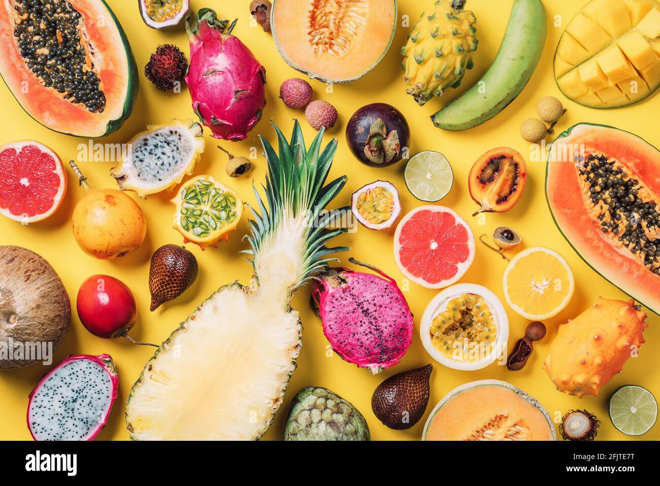 Tropical fruits concept. Exotic fruits - pineapple, papaya, mango, annona, banana, pitahaya, kiwano, african horned melon, tamarillo fruit, granadilla Stock Photo