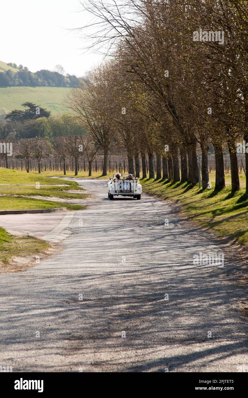 A Classic car drives off down country lane at start of Annual Charity