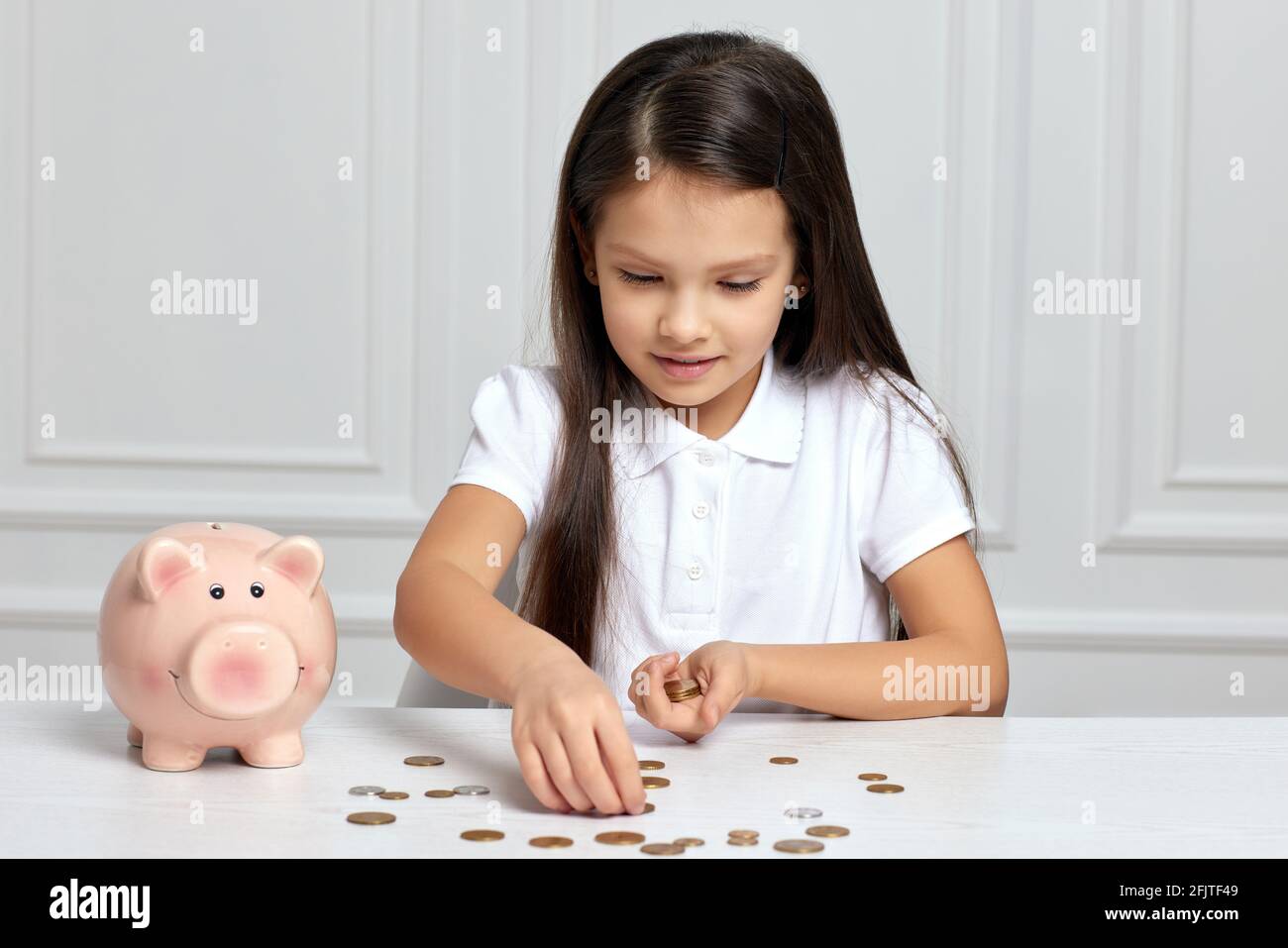 Little child girl with piggy bank at home Stock Photo - Alamy