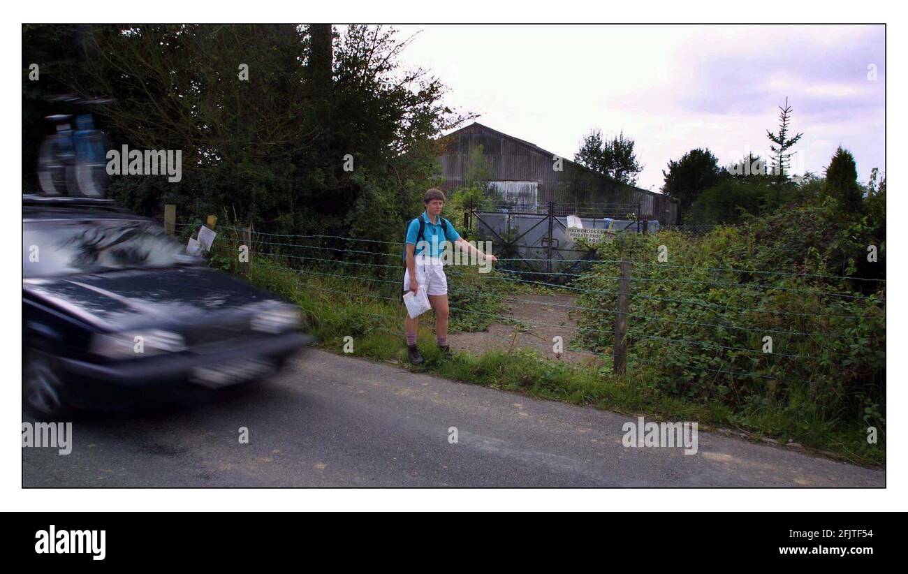 Kate Ashbrook, gen sec of Open Spaces society, with the baricade that have been erected by Nicholas van Hoogstraten across the entrance to the public highway running through his property High Cross Estate. Stock Photo