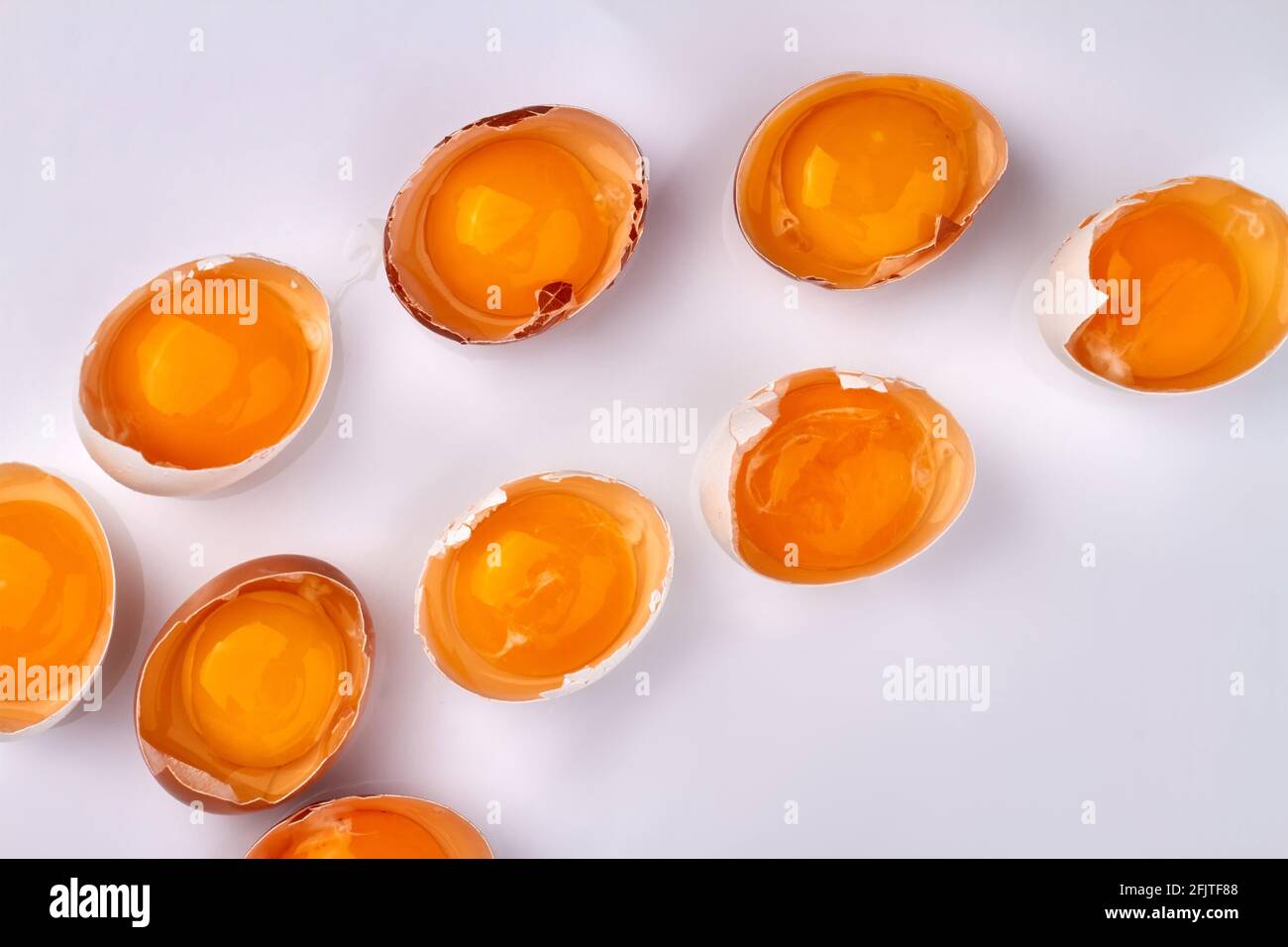 Broken chicken's eggs on white background. Stock Photo