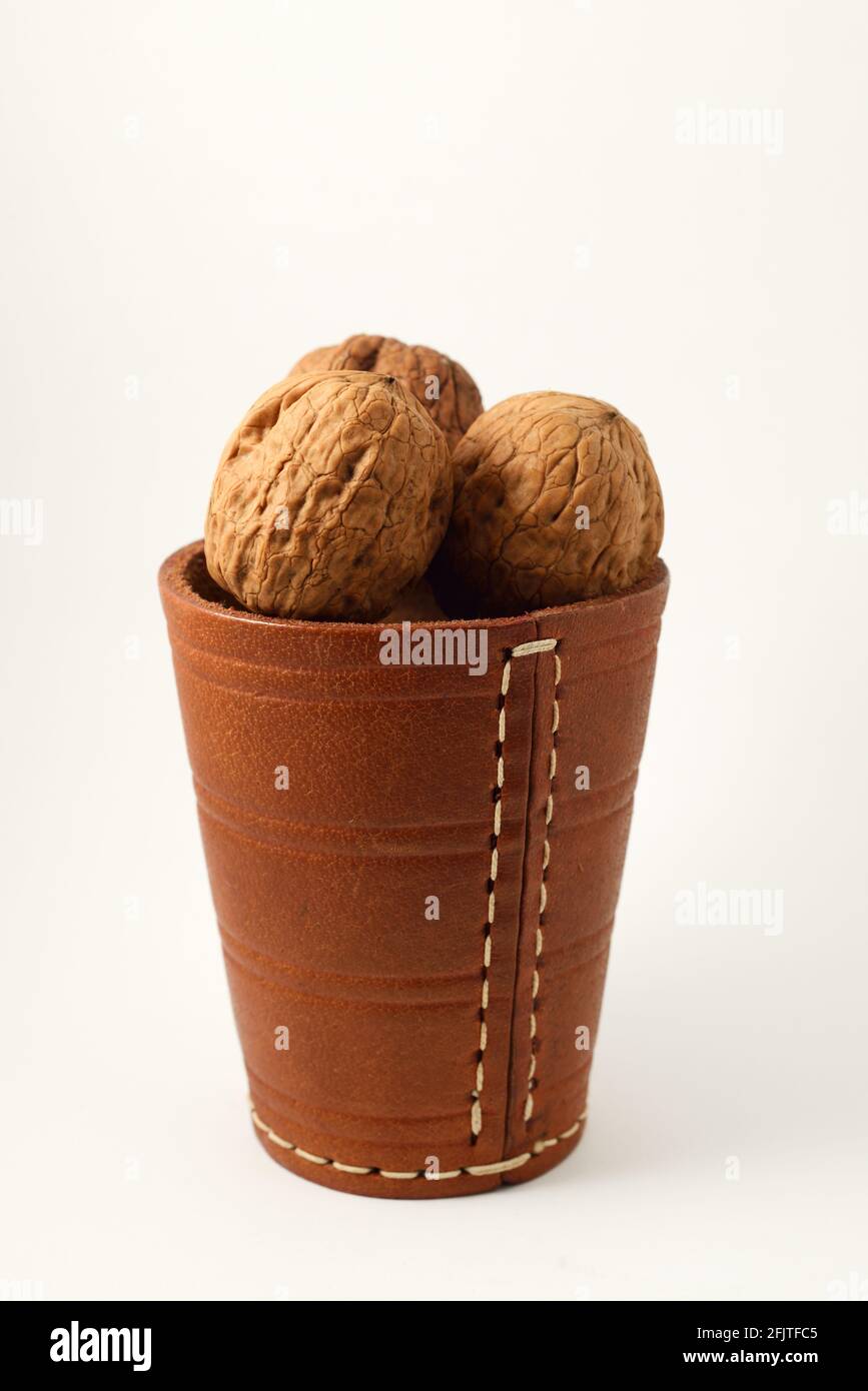 walnuts in a leather glass on a white background Stock Photo