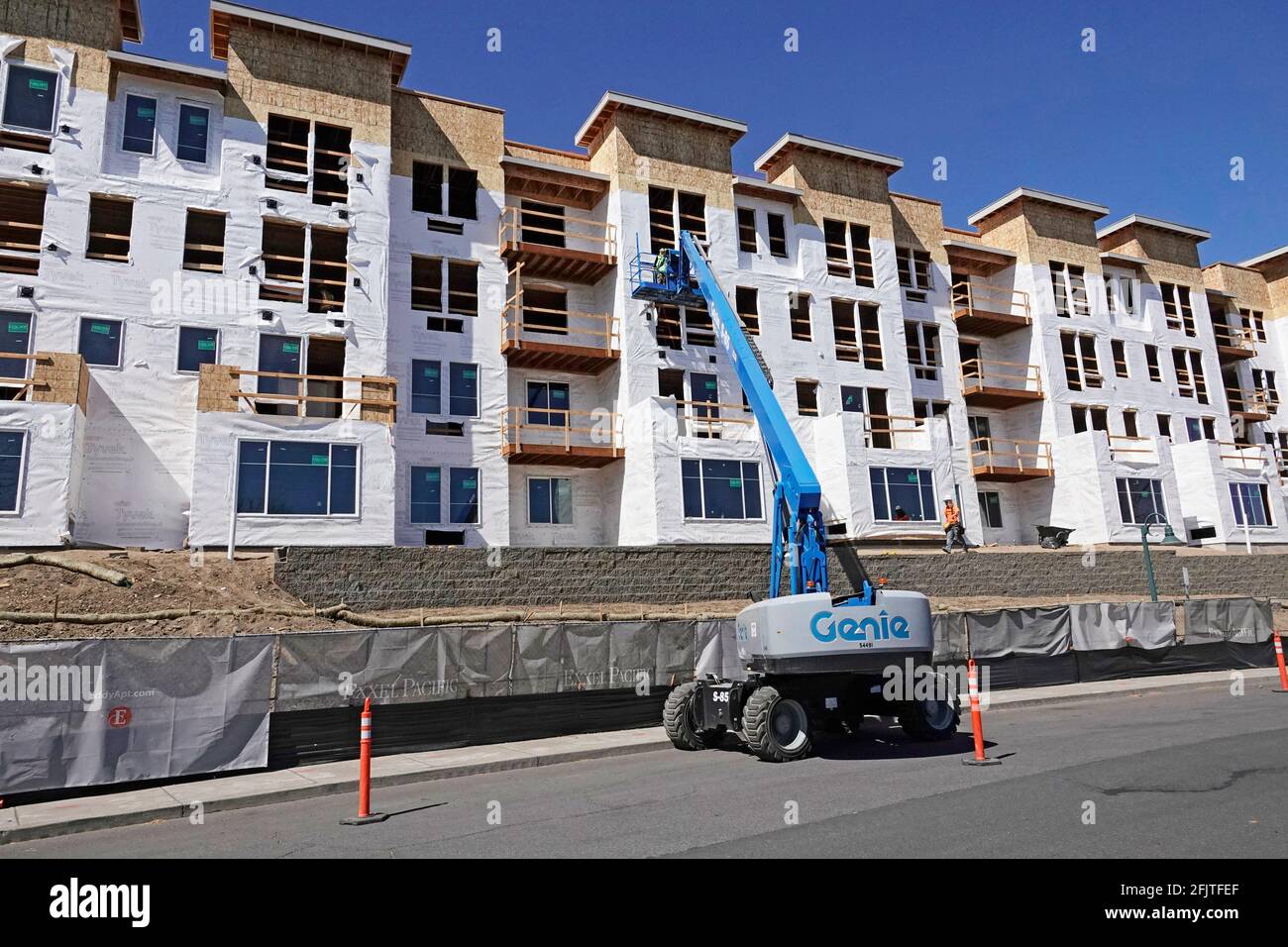 Construction workers put the final touches on a massive apartment