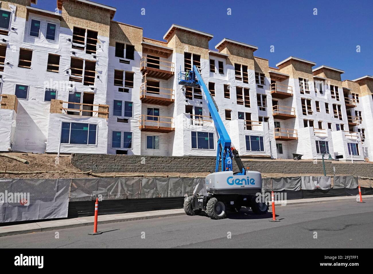 Construction workers put the final touches on a massive apartment