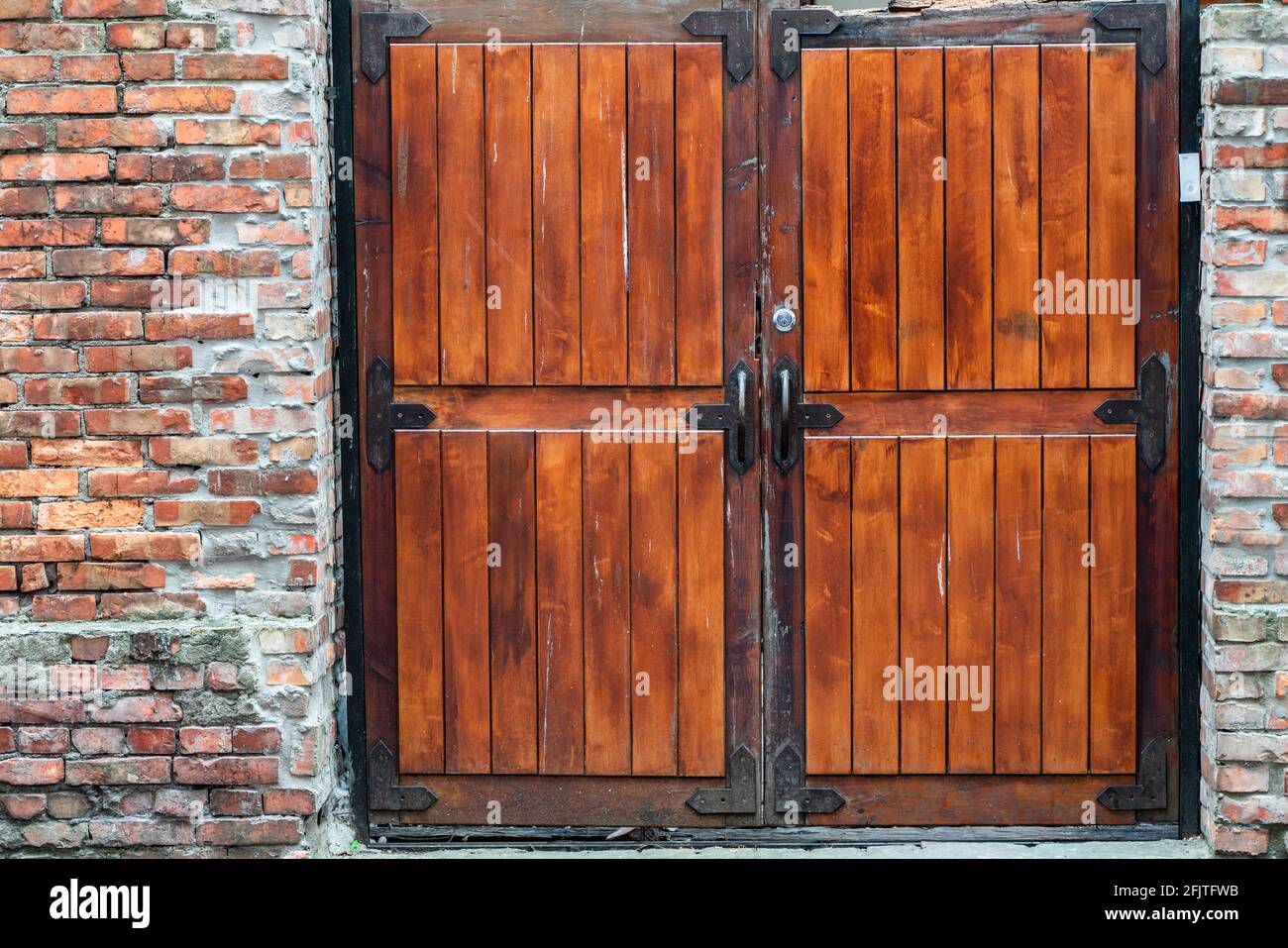 Red painted wooden barn door and window in old brick wall Stock Photo ...