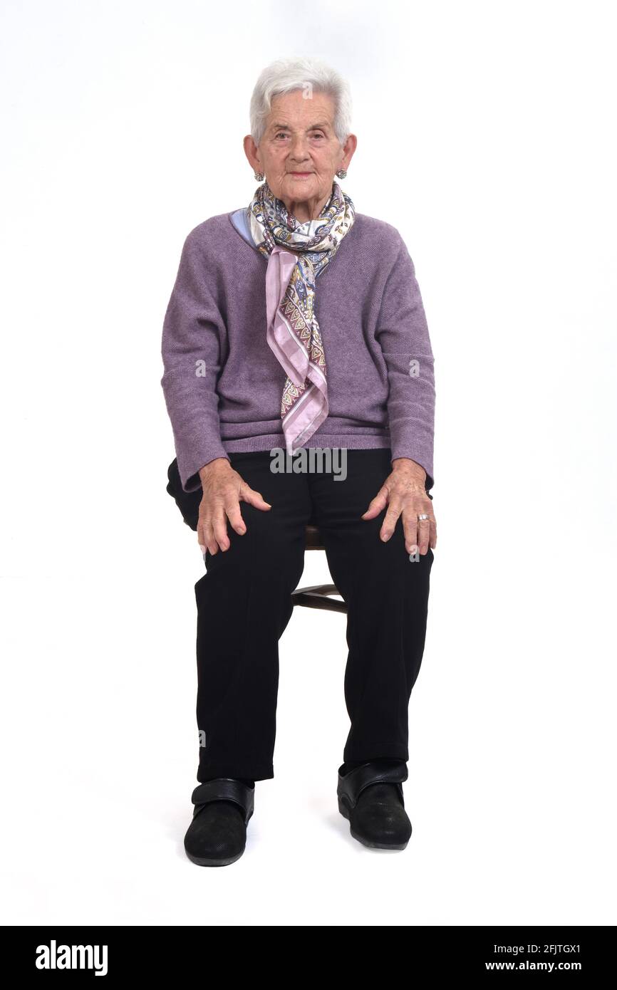 front view of senior woman sitting on chair on whte background Stock ...