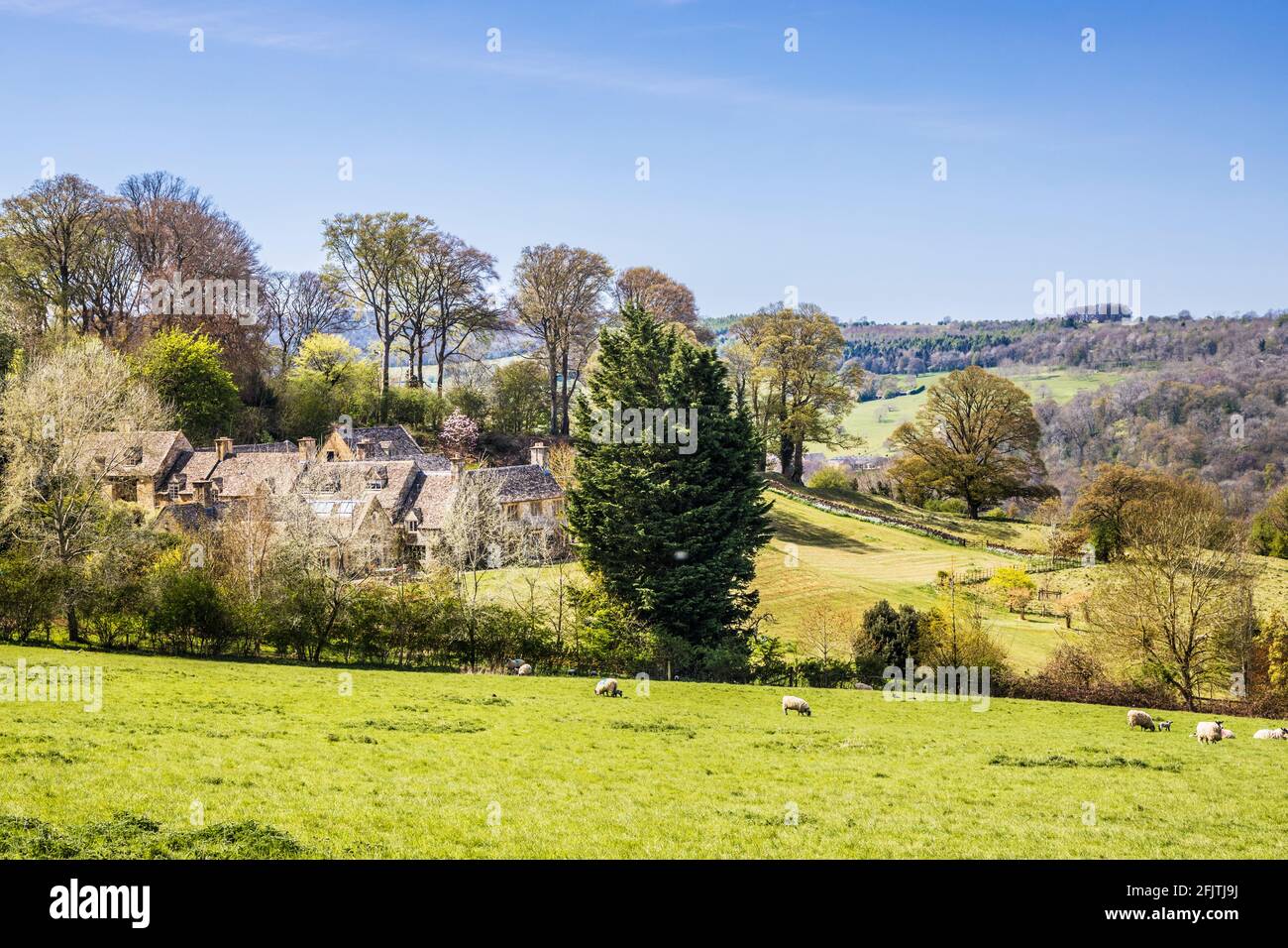 Attractive stone houses set amidst the rolling Cotswold countryside. Stock Photo