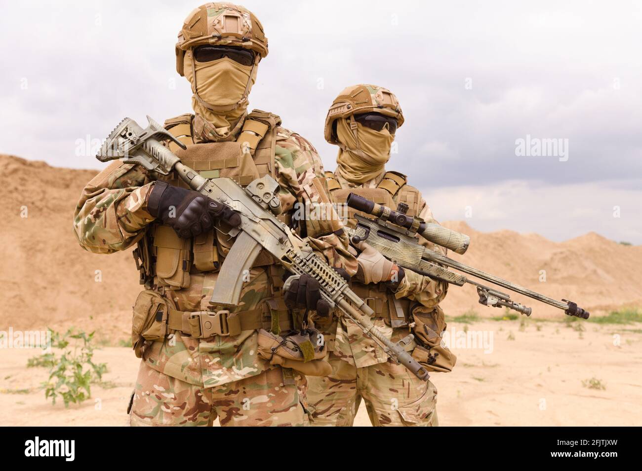 Two equipped and armed special forces soldiers standing in the