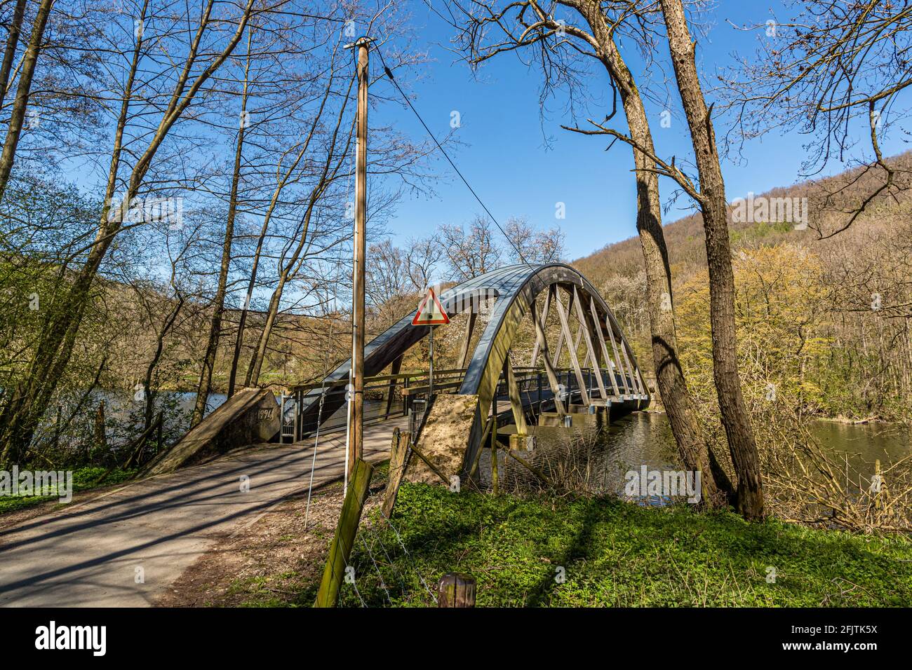 The stirrup bridge over the river Rur is held by a wooden arch truss near Nideggen, Germany Stock Photo