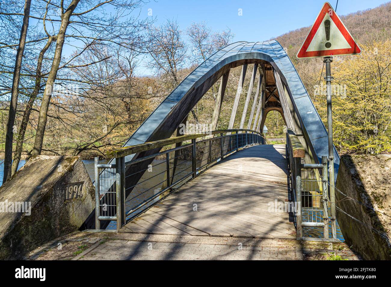 The stirrup bridge over the river Rur is held by a wooden arch truss near Nideggen, Germany Stock Photo