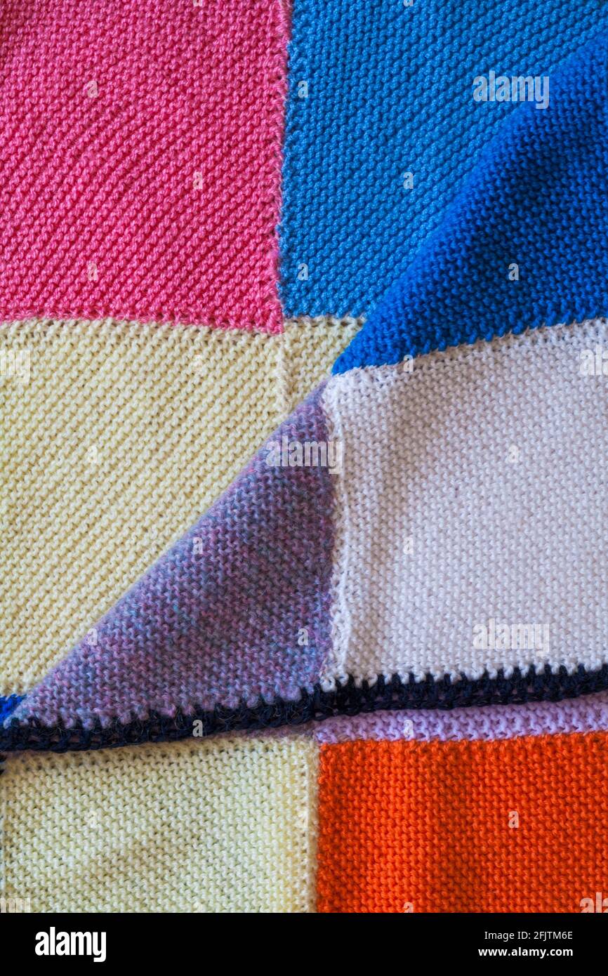 knitted squares sewn together to make a blanket, close up detail of