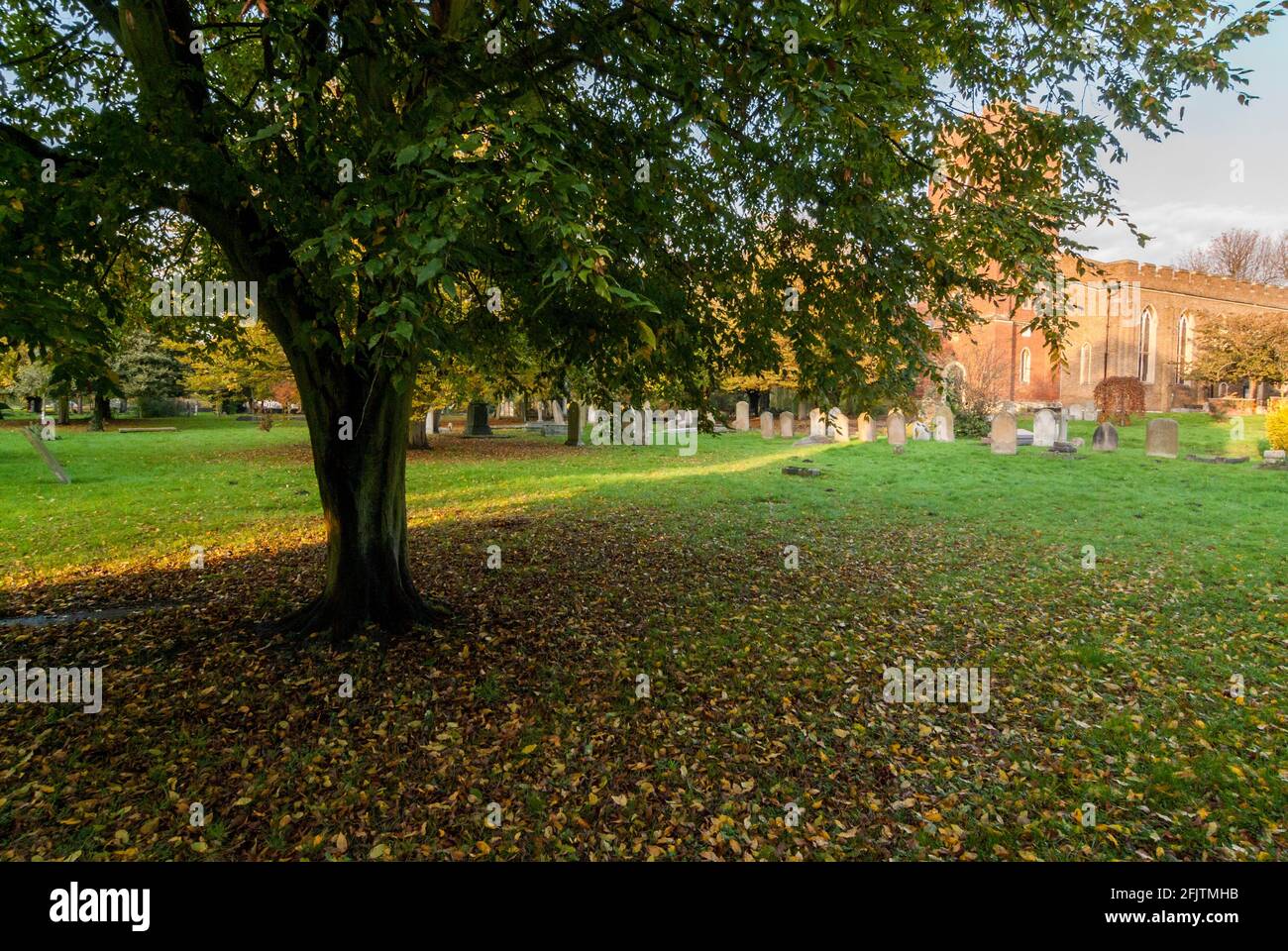 The churchyard of St Mary's Church, Staines-upon-Thames, UK, in autumn. Stock Photo
