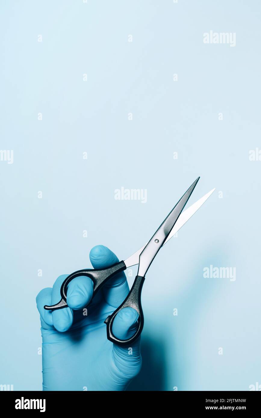 Hairdresser's hands with scissors. New normal concept. Copy space. Stay safe. Health protection equipment during quarantine Coronavirus pandemic Stock Photo