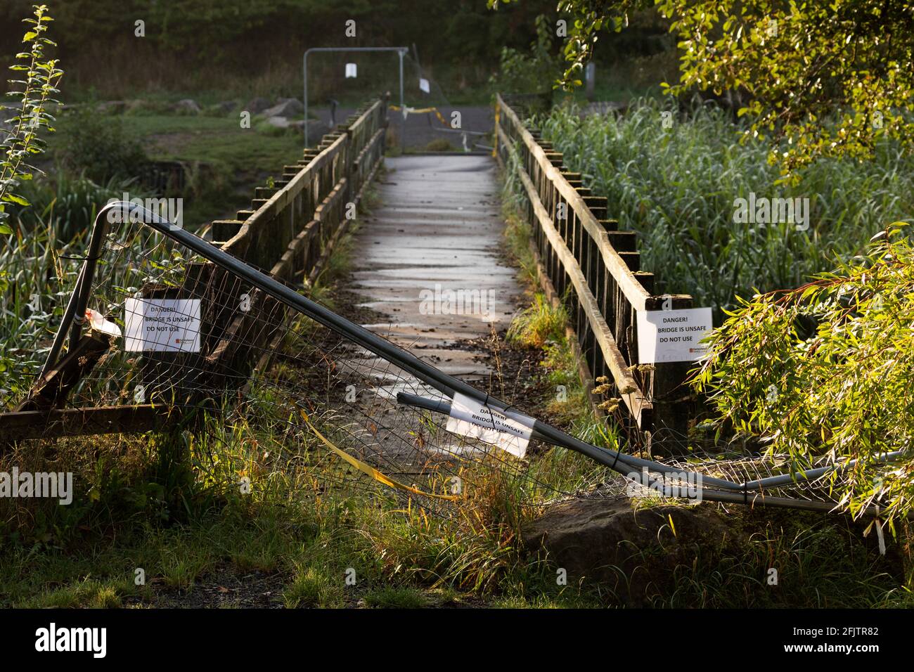 Damaged fencing by a bridge at Watergate Country Park in Gateshead, England. The fence was been vandalised. Stock Photo